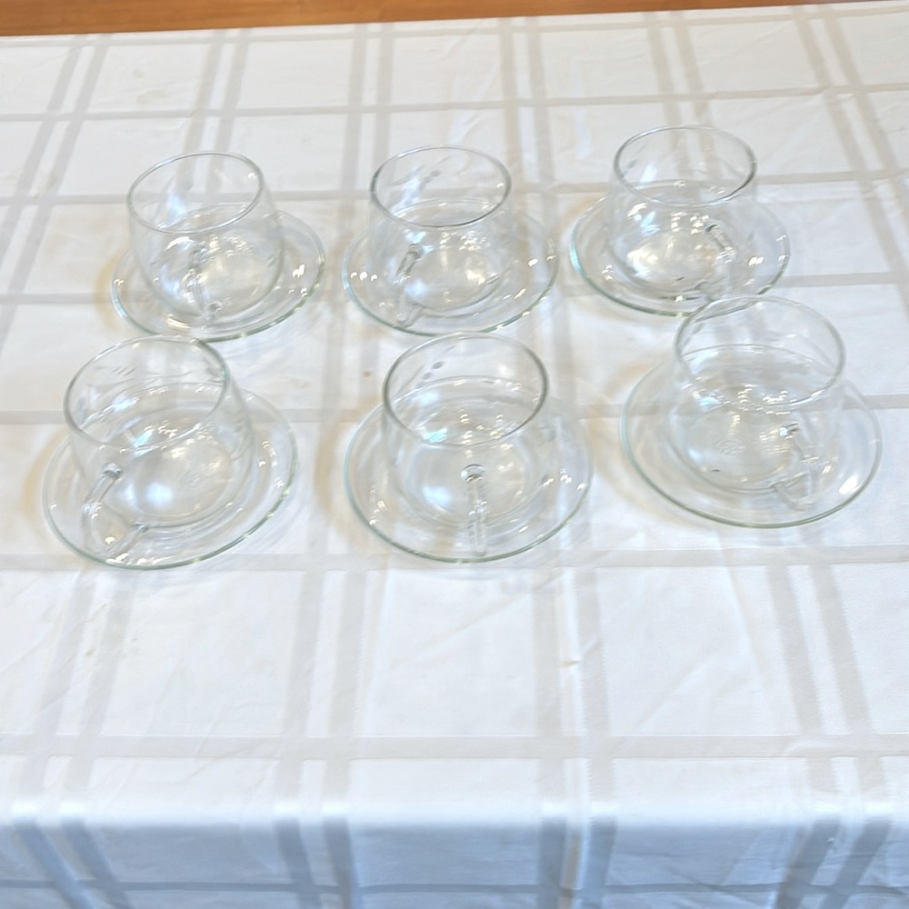 Hot glass cups with the saucers